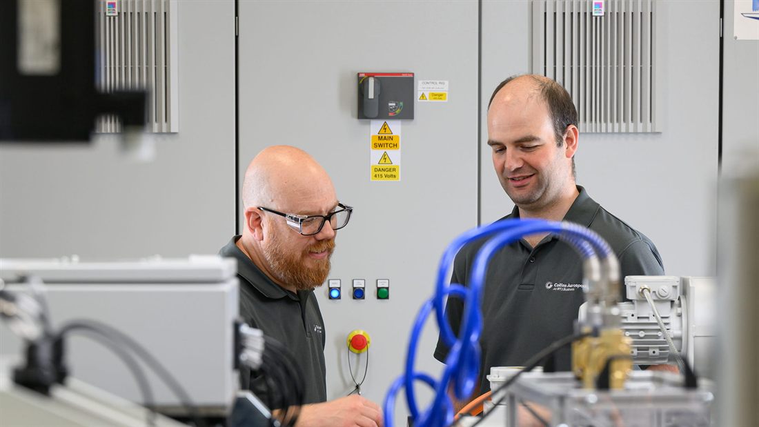 Collins Aerospace engineers at the control rig cabinet